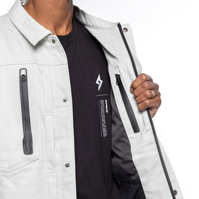 Male model wearing Anvil Chore Jacket in chalk colorway showing inside details. @color_chalk