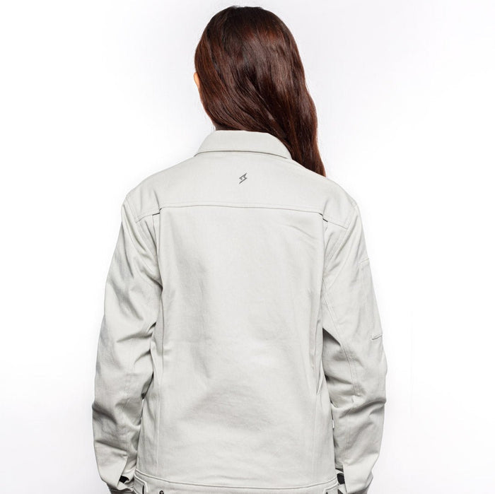 Back view of Female model wearing Anvil Chore Jacket in chalk colorway. @color_chalk