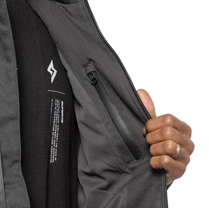 Male model showing inner details of Chisel Hooded Jacket in gravel colorway. @color_gravel