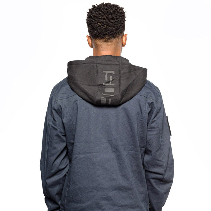 Back view of Male model wearing Chisel Hooded Jacket in midnight colorway. @color_midnight