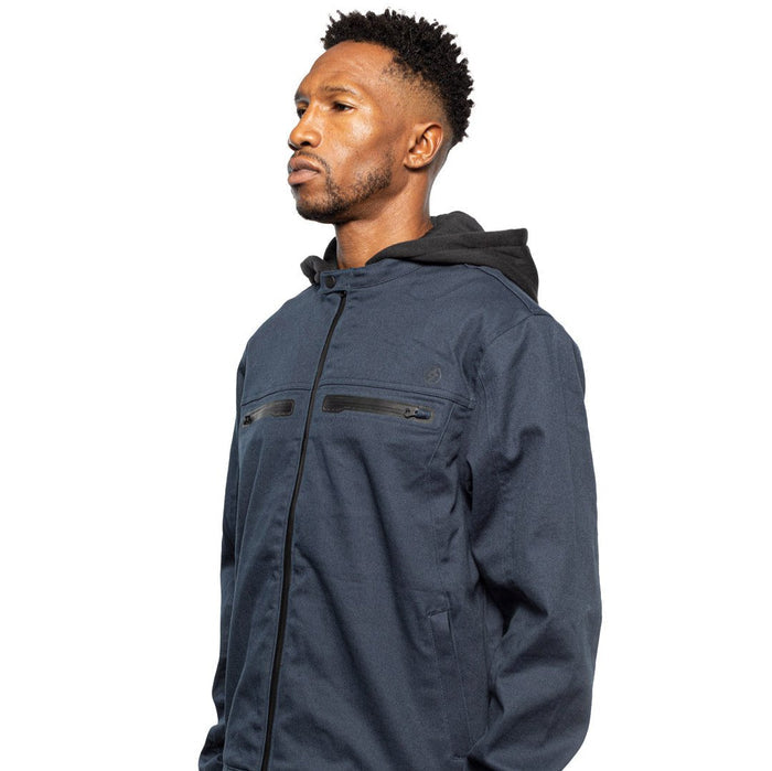 Side view of Male model wearing Chisel Hooded Jacket in midnight colorway. @color_midnight