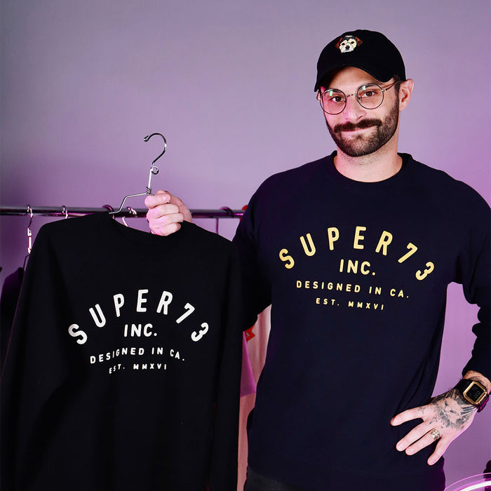 male model wearing Class of '73 Crewneck Sweatshirt in navy. @color_navy
