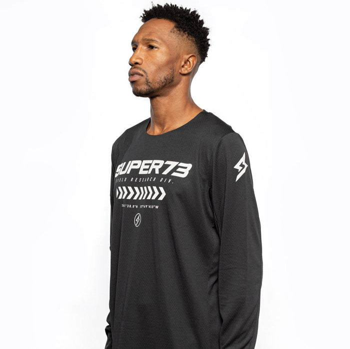 Male model side view of black Premium long sleeve athletic moto hoon jersey. @color_black