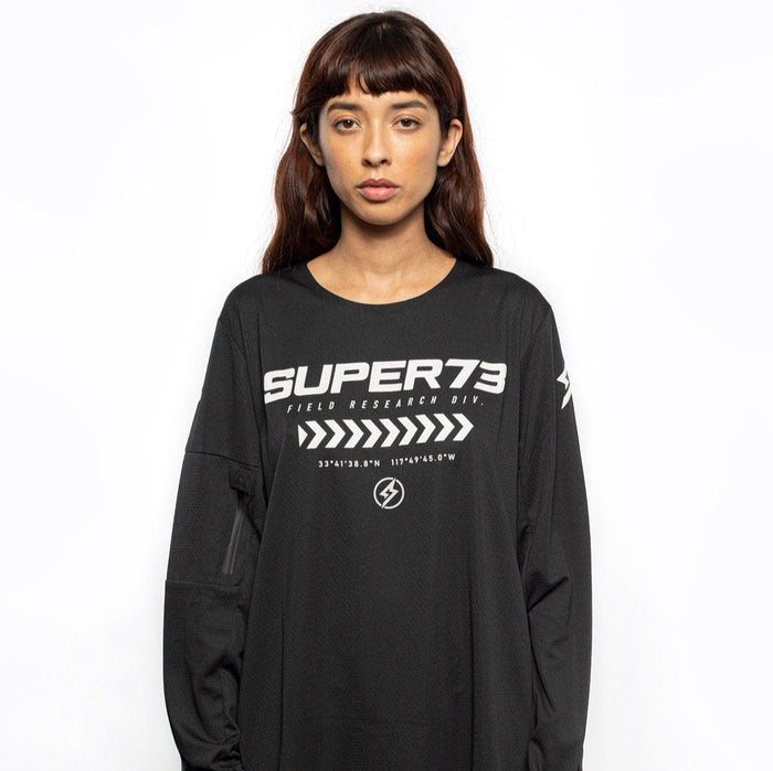 Female model front view of black Premium long sleeve athletic moto hoon jersey. @color_black