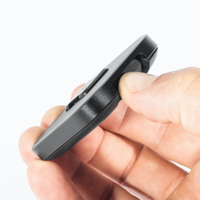 Close-up of a person's hand holding the Out Front Bike Mount V2 and engaging the release button.