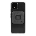 Peak Design Universal Phone Adapter installed on the back of a clear iPhone case.