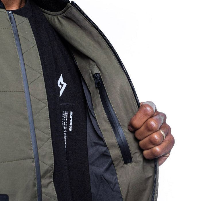 Male model showing inner details of Sipes Varsity Jacket in dark fatigue colorway. @color_dark fatigue