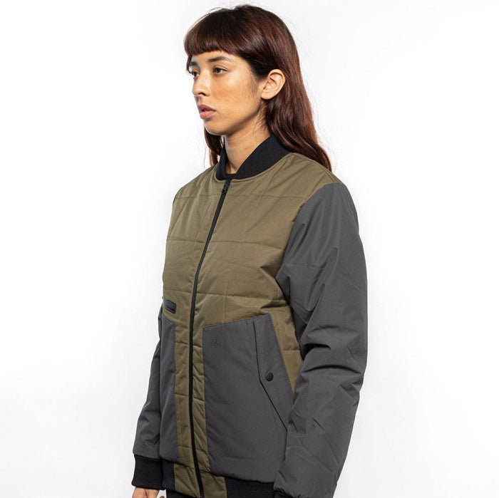 Side view of Female model wearing Sipes Varsity Jacket in dark fatigue colorway. @color_dark fatigue