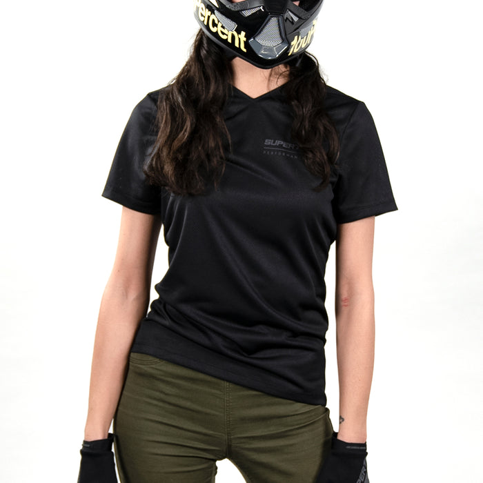 Woman wearing a SUPER73 x 100% Ridecamp Women's Jersey against a white background