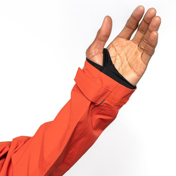 Sleeve detail shot of male model wearing Vale Packable Anorak in blood orange colorway. @color_blood orange